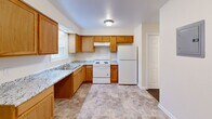 Located at 1523 E Grand Blvd in St. Louis, Missouri, this single-floor, 2-bedroom, 2-bathroom unit offers a straightforward and functional layout designed for comfortable everyday living. The kitchen is well-appointed with warm honey-toned wood cabinetry, granite-look countertops, a double sink, white appliances including an electric range and refrigerator, and tile flooring that extends into the adjacent dining area. Natural light enters through a window, keeping the space bright and practical. Both bedrooms are finished with soft wall-to-wall carpeting and neutral cream-toned walls that create a clean, understated atmosphere. The primary bedroom is a comfortable size and includes a sliding double-door closet along with a window overlooking the outdoors. The second bedroom is well-proportioned and equally inviting. The two bathrooms are finished with stone-look tile flooring and white fixtures, including a full tub-shower combination in one and a half bath configuration in the other. Throughout the unit, consistent neutral tones, white trim, and panel-style doors create a cohesive and tidy aesthetic. Two hallways connect the rooms efficiently, completing this well-organized and move-in ready home.