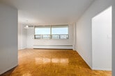Located at 2550 Kingston Rd, Unit 803 in Toronto's east end, this three-bedroom, one-bathroom unit is spread across a single floor with a functional and straightforward layout. Warm parquet flooring runs consistently throughout the living areas and all three bedrooms, adding a classic character to the space.

The open living and dining area is generously proportioned, benefiting from large windows that bring in natural light and offer views of the surrounding urban cityscape. Baseboard heating units are present throughout, ensuring comfort year-round.

The primary bedroom is notably spacious, easily accommodating large furniture arrangements, and features its own window with city views. The two additional bedrooms are well-sized and also feature windows with outdoor views and parquet flooring.

The galley-style kitchen is efficiently designed with white cabinetry, granite-effect countertops, a stainless steel sink, and light tile flooring. It provides ample storage and counter space along both walls.

The bathroom is cleanly finished with tile flooring, a vanity with a granite-effect countertop, a multi-bulb light fixture, and a bathtub. Two hallways connect the rooms, and a dedicated entrance provides a clear transition into the unit. The overall aesthetic is clean, neutral, and move-in ready.