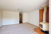 Located at 2802 Yulupa Ave in Santa Rosa, CA, this two-story, 2-bedroom, 3-bathroom home is thoughtfully laid out across two well-proportioned floors. The main level hosts a bright living room anchored by a distinctive terra-cotta tiled corner fireplace and sliding glass doors that open to an outdoor patio, filling the space with natural light. Adjacent, the kitchen features a wraparound tile-topped peninsula with a coil cooktop, warm wood cabinetry, a tile backsplash, and an overhead range hood — opening directly into the dining area with hardwood-style flooring and a ceiling light fixture. Upstairs, the spacious primary bedroom offers mirrored sliding closet doors, plush carpet, and a private sliding glass door leading to a balcony with outdoor views. The primary bathroom includes a dual-sink vanity with oak cabinetry and mosaic tile accents, leading to a separate tub-shower combo enclosed with sliding glass doors. The second bedroom is comfortably sized with a reach-in closet. Additional highlights include multiple closets for abundant storage, a utility room, and two staircases for convenient circulation. The home's consistent warm wood tones, tile details, and practical layout create a functional and cohesive living environment.