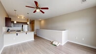 Located at 2010 Jennifer Dr in Davenport, FL, this well-designed one-bedroom, one-bathroom residence offers a smart, functional layout across a single floor. The open-concept living area seamlessly connects the kitchen, dining, and living spaces, creating a comfortable and cohesive environment. The kitchen is a standout feature, equipped with dark espresso cabinetry, granite countertops, a white subway tile backsplash, and a full suite of stainless steel appliances including a refrigerator, range, and microwave. A peninsula with pendant lighting provides additional counter space and serves as a casual dining area. Light wood-look flooring runs throughout the unit, complementing the neutral gray tones on the walls and adding a clean, contemporary feel. The living area is brightened by a ceiling fan with light fixture. The bedroom is a well-proportioned space, also featuring a ceiling fan, neutral walls, and the same light flooring, providing a calm and restful retreat. A dedicated closet offers convenient storage. The bathroom includes a full tub-shower combination, toilet, and dark vanity, finished with the same light flooring for a cohesive look. An in-unit laundry area adds everyday practicality to this move-in-ready home.