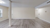 Located at 26 Beacon St in Burlington, MA, this well-appointed two-bedroom, one-bathroom residence offers a thoughtfully designed single-floor layout. The open-concept living area is bright and spacious, featuring light-toned hardwood-style flooring, neutral cream-colored walls, and a textured ceiling. A structural column adds an architectural accent to the main living space, which flows naturally into the kitchen and hallway beyond.

The kitchen is efficiently designed and equipped with white shaker-style cabinetry, granite-look countertops, a stainless steel dishwasher, range, and refrigerator — offering both style and functionality. A window allows natural light to brighten the space.

Both bedrooms are carpeted in warm neutral tones and feature windows with blinds that invite natural light. The spacious primary bedroom includes a sliding double-door closet for ample storage. The second bedroom is similarly proportioned and well-lit.

The full bathroom includes a combination tub and shower, toilet, and granite-look vanity countertop with tile flooring, maintaining a clean, cohesive aesthetic. A connecting hallway and dedicated closet round out the layout, providing practical storage and easy flow between all areas of the home.