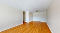 Located at 1020 Pembridge Crescent in Kingston, Ontario, this 2-bedroom, 1-bathroom unit offers a practical and well-organized single-floor layout. Warm hardwood-style flooring runs consistently throughout the entire space, creating a cohesive and inviting atmosphere from room to room.

The living room is a spacious, open area with neutral grey walls and flush ceiling lighting, providing a clean and versatile canvas. Adjacent to the living area, the galley-style kitchen features white cabinetry with chrome hardware, a single-basin sink, beige countertops, and white appliances including a stove and refrigerator, making efficient use of the available space.

Both bedrooms are well-proportioned with neutral walls and windows that allow natural light to fill the rooms and offer views of the surrounding outdoor landscape. Baseboard heaters are present in each bedroom. The primary bedroom is generously sized and includes access to a closet. The second bedroom is equally bright and functional.

The bathroom is clean and straightforward, featuring a full-size soaker tub with a tiled shower surround, chrome fixtures including a grab bar, and hardwood-style flooring continued from the rest of the unit. Two hallways connect the rooms efficiently, completing this neatly arranged and move-in-ready home.