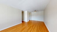 Located at 1020 Pembridge Crescent in Kingston, Ontario, this 2-bedroom, 1-bathroom unit offers a practical and well-organized single-floor layout. Warm hardwood-style flooring runs consistently throughout the entire space, creating a cohesive and inviting atmosphere from room to room.

The living room is a spacious, open area with neutral grey walls and flush ceiling lighting, providing a clean and versatile canvas. Adjacent to the living area, the galley-style kitchen features white cabinetry with chrome hardware, a single-basin sink, beige countertops, and white appliances including a stove and refrigerator, making efficient use of the available space.

Both bedrooms are well-proportioned with neutral walls and windows that allow natural light to fill the rooms and offer views of the surrounding outdoor landscape. Baseboard heaters are present in each bedroom. The primary bedroom is generously sized and includes access to a closet. The second bedroom is equally bright and functional.

The bathroom is clean and straightforward, featuring a full-size soaker tub with a tiled shower surround, chrome fixtures including a grab bar, and hardwood-style flooring continued from the rest of the unit. Two hallways connect the rooms efficiently, completing this neatly arranged and move-in-ready home.