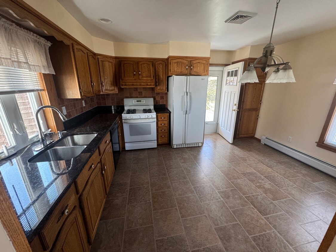 Kitchen includes gas range, dishwasher and fridge - 102 E Liberty St