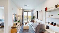Located at 700 Hamilton Avenue in Nashville, TN, this thoughtfully designed one-bedroom, one-bathroom residence offers a clean, modern aesthetic with high-quality finishes throughout. Light wood flooring flows seamlessly across the single-floor layout, complementing the bright white walls and recessed lighting that create a warm, airy atmosphere.

The living room serves as the heart of the home, anchored by a sliding glass door that opens onto a private balcony with treetop views — filling the space with abundant natural light. The combined kitchen and dining area is outfitted with light wood upper cabinetry, dark lower cabinets, a sage-toned tile backsplash, white quartz countertops, stainless steel appliances including a refrigerator, electric range, microwave, and dishwasher, and a matte black faucet — a cohesive and functional design.

The bedroom is a serene retreat with large windows framing outdoor greenery, offering peaceful views and natural light. The bathroom features a generous vanity with white quartz countertops, matte black fixtures, a glass-enclosed walk-in shower, and light wood-toned cabinetry. Additional conveniences include a dedicated laundry area and three closets, providing ample storage throughout this efficient and well-appointed residence.