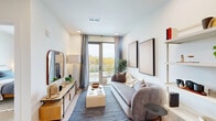 Located at 700 Hamilton Avenue in Nashville, TN, this thoughtfully designed one-bedroom, one-bathroom residence offers a clean, modern aesthetic with high-quality finishes throughout. Light wood flooring flows seamlessly across the single-floor layout, complementing the bright white walls and recessed lighting that create a warm, airy atmosphere.

The living room serves as the heart of the home, anchored by a sliding glass door that opens onto a private balcony with treetop views — filling the space with abundant natural light. The combined kitchen and dining area is outfitted with light wood upper cabinetry, dark lower cabinets, a sage-toned tile backsplash, white quartz countertops, stainless steel appliances including a refrigerator, electric range, microwave, and dishwasher, and a matte black faucet — a cohesive and functional design.

The bedroom is a serene retreat with large windows framing outdoor greenery, offering peaceful views and natural light. The bathroom features a generous vanity with white quartz countertops, matte black fixtures, a glass-enclosed walk-in shower, and light wood-toned cabinetry. Additional conveniences include a dedicated laundry area and three closets, providing ample storage throughout this efficient and well-appointed residence.