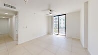 Located at 2101 Ludlam Rd in Miami, FL, this well-appointed 3-bedroom, 2-bathroom residence offers a thoughtfully designed single-floor layout with modern finishes throughout. The open-concept kitchen serves as the heart of the home, showcasing granite countertops, white shaker cabinetry, a mosaic tile backsplash, and a full suite of stainless steel appliances including a French door refrigerator, range, microwave, and dishwasher. A peninsula with a double basin sink and gold-tone faucet connects the kitchen seamlessly to the living area, which is illuminated by a chandelier and benefits from natural light pouring in through a large sliding glass door that opens to a private balcony. The primary bedroom is generously sized, featuring light wood-style flooring, a ceiling fan, and direct access to the hallway. Additional bedrooms also feature light wood flooring, ceiling fans, and windows with views of tropical greenery. Both bathrooms are finished with large-format neutral tiles, granite-topped vanities, and tub-shower combinations. Large-format porcelain tile floors run throughout the main living areas, contributing to the home's bright and cohesive aesthetic. The overall ambiance is clean, modern, and airy — well suited to Miami living.
