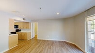 Located at 1855 Craigshire Rd in Maryland Heights, MO, this 2-bedroom, 3-bathroom residence offers a well-organized single-floor layout designed for comfortable everyday living. Light wood-tone flooring flows consistently throughout the main living areas and bedrooms, lending the space a warm, cohesive feel. The open living room is bright and inviting, highlighted by recessed lighting and a large window that draws in natural light and outdoor views. The galley-style kitchen is efficiently designed, featuring light wood cabinetry, white countertops, and a full suite of black appliances including a refrigerator, range, built-in microwave, and dishwasher. The primary bedroom is a comfortable retreat with wall-mounted sconce lighting, and the second bedroom also includes natural light from a window and matching sconce fixtures. The bathrooms are clean and functional — one features a wood-toned vanity with a wide mirror, bright vanity lighting, and light tile flooring, while another includes a full tub/shower combination. A dedicated closet provides additional storage. Neutral gray-toned walls throughout keep the overall ambiance calm and move-in ready.