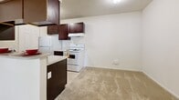 Located at 245 Brook Pines Dr in Columbia, SC, this single-floor, 3-bedroom, 1-bathroom home offers a practical and functional layout. The living area features neutral-toned carpet and a large picture window that fills the space with natural light while providing views of the surrounding greenery and neighborhood. The kitchen is equipped with dark espresso cabinetry, a white electric range, a refrigerator, and tile flooring, with a breakfast bar that opens toward the carpeted living area — ideal for casual dining or entertaining. The three bedrooms are carpeted throughout and feature neutral walls, with the spacious primary bedroom offering ample room for furnishings. Additional bedrooms include windows that invite natural light. The full bathroom includes a single-sink vanity with wood cabinetry, a tub/shower combination, and tile flooring. A hallway connects the main areas of the home, providing efficient flow between rooms. The home's clean, neutral palette throughout creates a versatile canvas ready for personalization. A keypad entry door adds a modern convenience to this straightforward and well-organized residence.