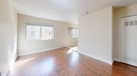 This 550 square foot apartment in Sacramento offers a practical and efficient living space. The single-floor layout comprises two bedrooms, one bathroom, a combined kitchen and living area, and a hallway. The primary bedroom, measuring 130 square feet, provides a comfortable retreat.

The interior boasts a neutral color palette with cream-colored walls, creating a bright and airy atmosphere. Large windows in the bedrooms and living area allow for ample natural light, enhancing the sense of space. The flooring varies throughout, with warm wood-look flooring in the main living areas and plush carpeting in the bedrooms.

The kitchen features white cabinetry, granite countertops, and essential appliances, including a gas range and refrigerator. The bathroom is outfitted with a single vanity, toilet, and tiled flooring. Ceiling fans in the bedrooms offer additional comfort and air circulation.

Storage solutions are integrated throughout, with mirrored closet doors in one bedroom maximizing space and light. The apartment's compact design makes efficient use of every square foot, ideal for those seeking affordable urban living without sacrificing modern amenities.