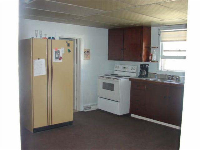 kitchen, has a newer stove and refrigerator now. - 101 S Plum St