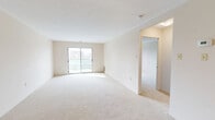 Located on the 7th floor at 310 Dundas Street in downtown London, Ontario, this well-appointed 2-bedroom, 2-bathroom unit offers a thoughtfully designed single-level layout. The open-concept living and dining area is bathed in natural light, with plush carpeting underfoot and a pendant light fixture that adds a warm, inviting atmosphere. A sliding glass door leads directly to a private balcony, extending the living space outdoors with city views.

The kitchen features white cabinetry and hardwood-style flooring, flowing seamlessly from the dining area. The spacious primary bedroom includes a large walk-in closet outfitted with wire shelving and hanging rails for ample storage. The second bedroom also features hardwood-style flooring, offering versatility as a guest room or home office.

Both bathrooms are finished in a clean, neutral palette. The main bathroom includes a full tub-shower combo with white tile surround, while the second bathroom features a vanity with a white countertop and warm wood-tone flooring. A dedicated laundry area houses a stacked washer and dryer unit for added convenience. Two hallways connect the layout efficiently, and a textured ceiling adds a classic residential character throughout the space.