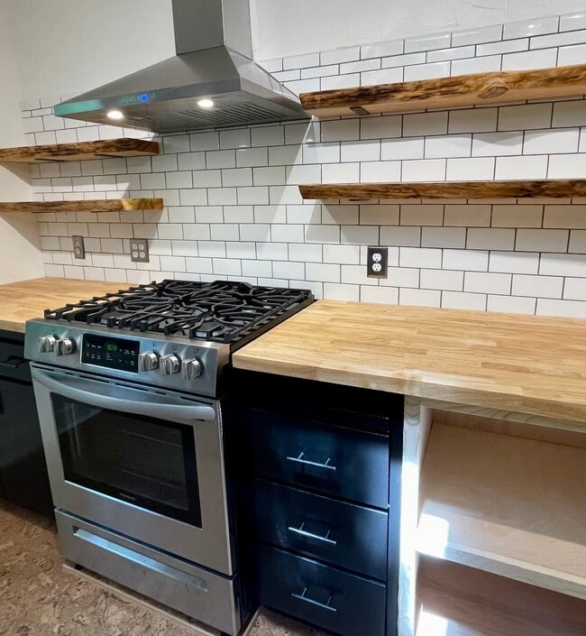 New gas range, live edge solid wood shelving, with ample storage space. - 6605 Shady Lake Ln