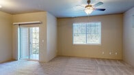 Located at 353 Dalton St in Medford, Oregon, this two-story home offers a practical and comfortable layout spread evenly across two floors. The main level features an open-concept kitchen and living room area. The kitchen is equipped with light maple cabinetry, a peninsula with a built-in sink and breakfast bar, laminate countertops, and a full suite of black appliances including a refrigerator, range, microwave, and dishwasher. Tile flooring runs throughout the kitchen, transitioning to plush carpet in the living area, which is brightened by natural light and a sliding glass door leading to a balcony. The upper floor houses the bedrooms, including a generously sized primary bedroom with a ceiling fan, multiple windows, and access to a private balcony. The second bedroom is carpeted and well-lit with a large window. Three bathrooms serve the home — one features a pedestal sink and tile flooring, another includes a vanity with granite-style countertops, a tub-shower combination, and convenient built-in shelving in an adjacent closet. Warm, neutral tones and consistent finishes create a cohesive aesthetic throughout the home.
