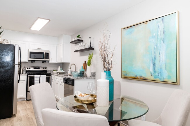 Dining area with hardwood-style flooring - Eastwood Greene