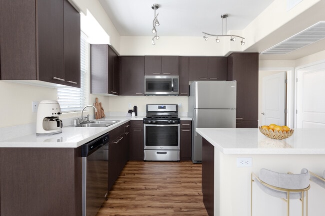 Cook, dine, and gather in a stylish kitchen space. - Vue at Centennial