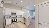 Located at 120 Market St in Pittsboro, NC, this thoughtfully designed single-floor residence offers a comfortable and modern living experience. The open-concept layout seamlessly connects the kitchen, dining, and living areas, creating a cohesive and functional space throughout.

The kitchen is a standout feature, showcasing crisp white shaker cabinetry, granite countertops with a classic subway tile backsplash, and a full suite of stainless steel appliances including a refrigerator, range, microwave, and dishwasher. A peninsula with pendant lighting and bar seating provides an ideal spot for casual dining and entertaining.

The living room is bright and welcoming, with large windows and a glass door that invite natural light and offer outdoor views. Light-toned luxury vinyl plank flooring flows throughout the main living areas, complementing the warm, neutral color palette.

The bedroom features plush carpeting, generous natural light from a large window with transom, and direct access to the full bathroom. The bathroom is well-appointed with granite countertops, ample cabinetry, and a tiled walk-in shower. A dedicated closet provides convenient storage, and a separate nook offers space for a home office or flex use. The overall ambiance is clean, airy, and move-in ready.