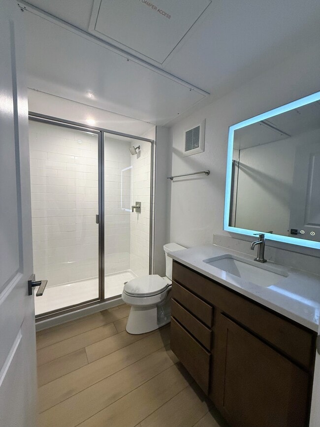 Beautiful bathroom with hot water shower, anti-fog mirror, and special lighting for skincare routine - 1650 Sheridan Blvd