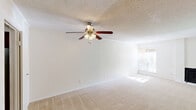Located at 4704 E 54th St in Tulsa, Oklahoma, this single-floor, 2-bedroom, 2-bathroom home offers a well-organized layout with comfortable living spaces throughout. The living room is generously sized, featuring plush wall-to-wall carpeting, a ceiling fan with light fixture, a textured ceiling, and a sliding glass door fitted with vertical blinds that allows natural light to pour in while providing access to an outdoor area. A fireplace adds a functional focal point to the living space.

The galley-style kitchen is efficiently designed with dark wood cabinetry, laminate countertops, hardwood-style flooring, and white appliances including a refrigerator, electric range, and dishwasher. A built-in microwave completes the setup. The kitchen opens conveniently toward the living area.

The spacious primary bedroom includes carpet flooring, a ceiling fan, a dedicated closet, and a private en-suite bathroom featuring a tub/shower combination with distinctive yellow tile surround and chrome fixtures. The second bedroom is also carpeted and ceiling fan-equipped. The second bathroom offers a clean tub/shower combination with neutral tile surround. Each bedroom includes closet storage, contributing to practical everyday functionality throughout the home.
