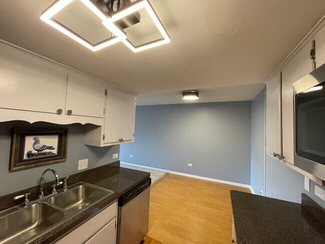 Kitchen with new modern lighting - 8200 Woodglen Ln