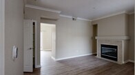 Located at 2300 Iron Point Rd in Folsom, CA, this two-story residence offers 3 bedrooms, 3 bathrooms, and a thoughtfully distributed layout across two floors. The main level provides generous living space, highlighted by a stylish living room adorned with crown molding, neutral warm-toned walls, and hardwood-style flooring. A tiled fireplace with a clean white mantle serves as the room's focal point, adding both warmth and character. A granite-topped breakfast bar connects seamlessly to the kitchen, which features rich dark cabinetry, granite countertops, and a full suite of stainless steel appliances including a refrigerator, dishwasher, microwave, and range. The main floor also includes additional living and hallway areas that enhance the sense of flow throughout the home. Upstairs, the three bedrooms are finished with plush carpet and receive natural light through well-placed windows. The primary bedroom includes sliding glass door access to an outdoor space. The three bathrooms are well-appointed with dark wood vanities, granite countertops, and clean tile surrounds. Closets provide practical storage throughout. The home's consistent use of neutral tones and quality finishes creates a cohesive and comfortable living environment.