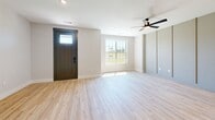 Located in Princeton, TX, this two-story home offers 3 bedrooms, 4 bathrooms, and a well-designed layout spread across two floors. The main level features an open-concept kitchen and living area with light hardwood flooring, a ceiling fan, and a bold dark front door that welcomes natural light. The kitchen is outfitted with white shaker cabinets, subway tile backsplash, a center island with quartz countertops, and stainless steel appliances. An attached garage with an automatic opener provides convenient access. Upstairs, the generously sized primary bedroom includes a walk-in closet with built-in shelving and hanging rods. The en-suite primary bathroom showcases patterned tile flooring, a dual-sink vanity with quartz countertops and matte black fixtures, and a glass-enclosed walk-in shower with white subway tile walls and hexagonal mosaic tile flooring. Additional bedrooms feature plush carpet, ceiling fans, and windows with views of the surrounding neighborhood. Secondary bathrooms mirror the home's consistent design with glass shower enclosures and clean white tile. A dedicated laundry room with hardwood flooring and built-in shelving adds everyday practicality. Neutral tones and recessed lighting throughout create a bright, cohesive ambiance.