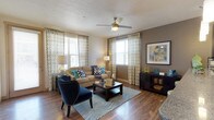 This single-floor residence offers a thoughtfully designed layout that balances style and functionality throughout. The living area serves as the heart of the home, featuring warm hardwood-style flooring, a ceiling fan, and multiple windows dressed with bold geometric-patterned curtains that invite an abundance of natural light. A textured ceiling adds character, while the open layout provides a comfortable and welcoming atmosphere.

The kitchen is a standout feature, equipped with dark espresso cabinetry, granite countertops, a mosaic tile backsplash, and a full suite of stainless steel appliances, including a range, microwave, and refrigerator. A breakfast bar with pendant lighting creates a casual dining space that connects seamlessly to the main living area.

The bedrooms are carpeted for comfort, each offering ceiling fans, natural light from well-positioned windows, and ample space for rest and relaxation. The bathroom is finished with dark cabinetry, granite countertops, tile flooring, and a tub-shower combination. A dedicated in-unit laundry area with a full-size washer and dryer adds everyday convenience, completing this efficiently designed and move-in ready residence.