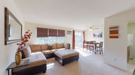 Located at 51 Rockwood Cir in Middletown, NY, this single-floor residence offers a well-organized layout that balances comfort and functionality. The open-concept living and dining area is a central highlight, filled with natural light streaming through multiple windows dressed with roman shades and sliding glass door access to a balcony. A ceiling fan overhead and neutral carpet underfoot create a relaxed atmosphere throughout this shared space. The kitchen is positioned adjacent to the living area and features warm wood cabinetry, granite-style countertops, a gas range, and tile flooring, making it both practical and efficient. The primary bedroom is generously sized with soft carpet, ample closet space, and a calm, neutral palette. A second bedroom offers additional built-in closet storage, a wall-mounted air conditioning unit, and a large window with views of surrounding greenery. The bathroom includes a window for natural ventilation and light. Throughout the residence, baseboard heating ensures year-round comfort. The overall ambiance is bright, clean, and well-maintained, making this a comfortable and move-in ready home in a residential Middletown neighborhood.