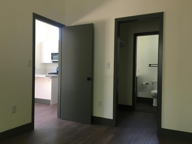 View from quiet bedroom into walk-in closet and the living area. - 221 Wapello St