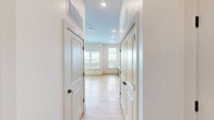 Located at 212 Durham Ave in Metuchen, NJ, this efficiently designed single-floor unit offers a clean, contemporary aesthetic throughout. Light wood flooring runs continuously across the living space, creating a warm and cohesive feel. The open-concept living area is bright and airy, benefiting from multiple windows fitted with white horizontal blinds that frame leafy outdoor views and allow generous natural light to fill the space. A ceiling fan with integrated lighting adds both comfort and a modern touch to the main room, which also includes a double-door closet for storage.

The kitchen is thoughtfully outfitted with a full suite of stainless steel appliances, including a refrigerator with water dispenser, electric range with over-the-range microwave, and dishwasher. Two-tone cabinetry — white upper cabinets paired with gray lower cabinets — is complemented by a white countertop and a sleek black-hardware sink, lending the kitchen a modern, polished character.

The bathroom continues the light wood flooring from the rest of the unit and features a clean white vanity, toilet, and matte black hardware accents including grab bars and hooks, offering both style and practicality. Throughout the unit, white walls and minimalist finishes create a bright, move-in-ready environment ideal for those seeking modern, low-maintenance living in central New Jersey.