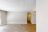 Located at 203 Eastdale Rd S in Montgomery, Alabama, this single-story 2-bedroom, 2-bathroom home offers a functional and comfortable layout designed for everyday living. The open living and dining area features warm wood-look flooring and neutral gray walls, with a textured ceiling that adds subtle character. A hallway connects the main living space to the private quarters of the home. The kitchen is well-equipped with white shaker-style cabinetry, light granite-look countertops, a stainless steel sink, and black appliances including a refrigerator, range, and dishwasher. Wood-look flooring and track lighting complete the galley-style space. Both bedrooms are carpeted and include ceiling fans with lighting. The primary bedroom features an en-suite bathroom and dedicated closet space, while the second bedroom offers a window with natural light and its own closet access. The home includes four closets total, providing generous storage throughout. A dedicated laundry area adds everyday convenience. A standout feature is the secondary room with French doors that open to a private patio, allowing natural light to fill the space and providing a seamless indoor-outdoor connection. The consistent neutral palette and wood-look flooring throughout create a cohesive and inviting atmosphere.