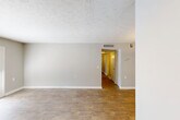 This 880 square foot single-story residence in Montgomery, Alabama offers a well-designed layout with three bedrooms, a living room, kitchen, and hallway. The primary bedroom, measuring 170 square feet, provides ample space for comfort. Throughout the home, neutral-toned walls create a bright, airy atmosphere, complemented by modern ceiling fans in multiple rooms for enhanced air circulation.

The living areas showcase attractive wood-look flooring, adding warmth and durability to the space. In contrast, the bedrooms feature plush carpeting for a cozy feel underfoot. Large windows in various rooms allow natural light to flood the interior, while providing views of the surrounding area.

The kitchen has been updated with white cabinetry, light-colored countertops, and black appliances, creating a clean and modern aesthetic. The galley-style layout maximizes efficiency in this functional cooking space.

French doors in one room lead to an outdoor area, extending the living space and providing easy access to fresh air. Built-in storage solutions, such as the closet with upper shelving, offer practical organization options.

Overall, this home combines modern amenities with a practical layout, making it an inviting and comfortable living space in a desirable Montgomery location.