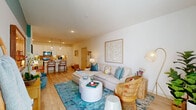 Located at 1005 Brentwood Dr in Davenport, FL, this thoughtfully designed one-bedroom, one-bathroom home offers a cohesive, single-level layout that maximizes every inch of its well-proportioned footprint. Light-toned wood-look flooring flows throughout the main living areas, tying together a bright and airy aesthetic.

The open-concept living and dining area serves as the heart of the home, featuring large windows dressed with linen drapes that invite natural light. A vibrant teal accent wall adds a playful coastal character to the space.

The kitchen is sleek and functional, showcasing white shaker cabinetry extending to the ceiling, stainless steel appliances, a white quartz peninsula with bar seating, and statement globe pendant lights overhead — ideal for both cooking and entertaining.

The bedroom is carpeted for comfort and includes two closets, offering generous storage. The full bathroom is finished with white cabinetry, a quartz countertop, wood-look tile flooring, and a tub-shower combo clad in clean white subway tile.

Additional highlights include an in-unit laundry area, a pantry, a hallway connecting the private spaces, and a patio for outdoor enjoyment. The overall ambiance is fresh, modern, and move-in ready.