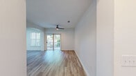 Located at 7000 Johnson Farm Lane in Chadds Ford, PA, this well-appointed single-floor residence offers three bedrooms and three bathrooms thoughtfully arranged for comfortable living. The open living room features light wood-look flooring, a ceiling fan with access to natural light through sliding doors, and elegant arched doorways that lend architectural character throughout the space. Built-in shelving in the living area provides practical storage and display options.

The kitchen is designed for both function and style, showcasing white cabinetry, a white quartz countertop with a peninsula breakfast bar, stainless steel appliances including a refrigerator and electric range, a stainless steel sink with a matte black faucet, and arched pass-through access to adjoining spaces.

The bathrooms are finished with modern touches, including one featuring a double-sink vanity with white cabinetry, a large mirror, matte black hardware, and warm wood-look flooring. The bedrooms are carpeted in a neutral tone, offering a soft, comfortable feel. A dedicated laundry room houses a full-size side-by-side washer and dryer with overhead wire shelving for added storage. The hallway connects all rooms efficiently, maintaining a clean, cohesive flow throughout this move-in-ready home.