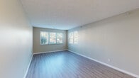 Located at 1808 Bordeaux Blvd in Burlington, Kentucky, this single-floor residence offers a well-designed, open-concept layout finished with consistent light wood-style flooring throughout. The living area is generously proportioned, featuring large multi-pane windows that admit abundant natural light and offer views of the surrounding greenery. A textured ceiling adds subtle architectural detail to the space, while neutral warm-gray walls provide a versatile backdrop.

The kitchen is a functional highlight of the home, outfitted with white shaker-style cabinetry, granite-look countertops, and a full suite of stainless steel appliances including a refrigerator, electric range, and dishwasher. A peninsula with pendant lighting above creates a natural division between the kitchen and the open living area, ideal for casual dining or entertaining.

The bedrooms are well-sized with ample natural light from single windows and closet access. The bathrooms feature clean, neutral finishes with tub-shower combinations, light wood-style flooring, wide vanity mirrors, and bright overhead lighting. The overall ambiance throughout the home is clean, modern, and move-in ready, with a cohesive neutral palette that suits a wide range of interior styles.