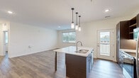 Step into a world of endless possibilities in this beautifully crafted 750 sq ft home. The heart of this stunning property is the open-concept kitchen and living area, where culinary dreams come to life amidst sleek, dark wood cabinetry and gleaming quartz countertops. The kitchen island, perfect for casual dining or entertaining, invites you to create unforgettable memories with loved ones.

Natural light floods every corner through large windows, creating an airy and inviting atmosphere throughout. The primary bedroom, a generous 150 sq ft retreat, offers a serene escape after a long day. The second bedroom provides versatility as a guest room, home office, or personal sanctuary.

Indulge in the luxury of the modern bathroom, complete with a stylish vanity and the convenience of in-unit laundry. Rich, warm-toned hardwood floors flow seamlessly through the space, adding a touch of elegance and warmth to your daily life.

This home isn't just a place to live; it's a canvas for your aspirations. Whether you're a first-time homebuyer, a young professional, or looking to downsize without compromising on quality, this property offers the perfect blend of style, function, and comfort. Embrace a lifestyle of ease and sophistication in this thoughtfully designed space that's ready to become your personal oasis in the heart of Kalamazoo.