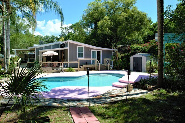 Rear of Home w Tropical View of Pool & Three Covered Areas - 139 E 8th St