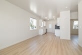 This newly constructed single-story home in Twin Falls, Idaho offers a clean, modern design with a thoughtful layout across two bedrooms, one bathroom, and a combined kitchen and living area. Light-toned hardwood-style flooring runs throughout the entire home, complementing the crisp white walls and creating a bright, cohesive aesthetic.

The open-concept living and kitchen area serves as the heart of the home. The kitchen features white shaker-style cabinetry, light quartz countertops, a stainless steel sink, and a dishwasher, with ample upper and lower cabinet storage. Multiple windows flood the space with natural light and provide views of the surrounding neighborhood.

Both bedrooms are well-proportioned, featuring the same light flooring and neutral walls, with one bedroom offering a window with a neighborhood view. Two closets provide practical storage throughout the home. The full bathroom includes a tub-shower combination with tiled surround, a white vanity with matching countertop, and a toilet.

The home is part of a newly developed residential community, with a concrete driveway and a yard area that offers the opportunity for future landscaping. The single-floor layout ensures easy accessibility, while the fresh construction throughout delivers a move-in-ready experience.