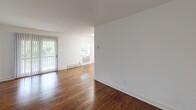 This one-bedroom, one-bathroom residence at Jumping Brook in Neptune, NJ offers a well-designed single-floor layout with a comfortable and functional living environment. Rich, warm-toned hardwood flooring runs throughout the living areas and bedroom, adding character and a sense of cohesion to the space.

The living room is spacious and bright, featuring large vertical-blind-covered sliding doors and windows that invite natural light and provide outdoor views. Baseboard heating runs along the perimeter, ensuring year-round comfort.

The kitchen has been thoughtfully updated with crisp white shaker-style cabinetry, dark stone-look countertops, a subway tile backsplash, and a full suite of stainless steel appliances including a refrigerator, dishwasher, electric range, and over-the-range microwave. Light-toned flooring complements the clean, modern aesthetic.

The bedroom is generously sized with hardwood floors, a window with blinds for natural light and privacy, and an impressive double-closet configuration featuring two separate sliding-door closets with hanging rods, offering abundant storage.

The bathroom is finished with clean white subway tile surrounding a full tub/shower combination, maintaining a simple and timeless look throughout. Overall, the unit presents a clean, move-in-ready space with updated finishes in a well-established Neptune community.