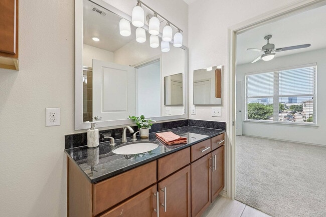Spacious bathroom with upgraded finishes and a glass-enclosed shower. - McDermott 55