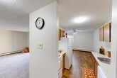 Located at 3830 105 Street NW in Edmonton, Alberta, this three-bedroom, one-bathroom unit offers a practical and well-organized single-floor layout. The open-concept kitchen and dining area features warm wood-toned cabinetry, a white appliance suite including a refrigerator, stove, and dishwasher, and durable hardwood-style flooring. A ceiling fan in the dining area adds comfort, while a window brings in natural light. The adjoining living room is carpeted and connects to a balcony, providing outdoor views and additional natural light through a sliding glass door. Each of the three bedrooms is carpeted and features baseboard heating, windows with outdoor views, and louvred bifold closet doors — with the primary bedroom offering an especially generous built-in closet. The unit includes four closets in total, providing ample storage throughout. The bathroom is equipped with a full tiled tub-and-shower surround with classic white square tile detailing. Textured ceilings are consistent throughout the unit. A central hallway connects the main living areas to the bedrooms, creating a clear and efficient flow. This unit offers a comfortable and functional living arrangement in a well-established Edmonton neighbourhood.