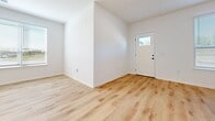 This contemporary 1180 square foot apartment offers a thoughtful blend of functionality and style. The open-concept design seamlessly integrates the kitchen, living, and dining areas, creating a spacious feel. The kitchen is a highlight, featuring crisp white cabinetry, stainless steel appliances, and a large island with granite countertops, perfect for casual dining or entertaining.

Both bedrooms are generously sized, with the primary bedroom measuring 170 square feet. Each bedroom boasts ample closet space, with sliding barn doors adding a touch of modern farmhouse charm. The two full bathrooms are well-appointed with sleek fixtures and vanities.

The apartment's flooring is a consistent light wood throughout, enhancing the bright and airy atmosphere. Large windows in the bedrooms and living areas allow for plenty of natural light. The in-unit laundry room is equipped with modern, full-sized Whirlpool washer and dryer units.

An attached garage provides convenient parking and additional storage space. The property's location at 700 W Capitol Dr in Hartland, WI, offers a balance of suburban tranquility and accessibility. With its modern amenities and thoughtful design, this apartment presents an ideal living space for those seeking comfort and style.