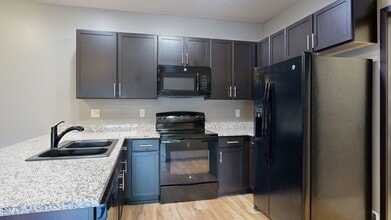 Cook and connect in our modern kitchens with granite countertops, sleek cabinetry, and plenty of room for meal preparation. - Villas of Omaha at Butler Ridge