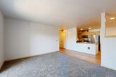 Located at 1616 E Marine View Dr in Everett, WA, this well-appointed one-bedroom, one-bathroom unit offers a functional and comfortable layout across a single floor. The open-concept living, dining, and kitchen area forms the heart of the home, with warm wood-look laminate flooring flowing through the kitchen and dining space, transitioning to plush carpet in the living area. The kitchen is thoughtfully designed with wood-toned cabinetry, dark countertops, a double-basin sink, and a full suite of stainless steel appliances including a refrigerator, microwave, and dishwasher. A breakfast bar provides a natural division between the kitchen and living space. The living room is bright and spacious, filled with natural light from a sliding glass door that opens onto a private balcony with outdoor views. The bedroom features carpet flooring and a generously sized window overlooking the surrounding neighborhood, allowing ample natural light. Three closets provide excellent storage throughout the unit. The bathroom includes a full soaking tub with a clean, white surround. Additional conveniences include an in-unit laundry area and a hallway connecting the private spaces. The unit's clean, neutral palette and modern finishes create a bright and welcoming atmosphere throughout.