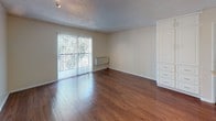 Located in Garden Grove, California, this single-floor residence offers a thoughtfully designed layout with warm hardwood flooring throughout. The open living area is bright and welcoming, featuring sliding glass doors with vertical blinds that invite natural light and provide access to an outdoor balcony with greenery views. A built-in storage unit adds practical charm to the living space.

The kitchen is efficiently designed with white cabinetry, granite-style countertops, a stainless steel sink, a stainless electric range, and a refrigerator. An adjacent dining area provides comfortable space for everyday meals, all beneath a textured ceiling with flush-mount lighting.

The bathroom is well-appointed, featuring a dual-sink vanity with white cabinetry, granite-style countertops, and a well-lit mirror. Wood-look flooring extends into this space, maintaining a cohesive aesthetic. A separate full bath includes a tub-shower combination with chrome fixtures.

Throughout the unit, neutral wall tones, white trim, and consistent wood-style flooring create a clean and cohesive atmosphere. The textured ceilings and ample storage options add both character and functionality to this comfortable Garden Grove residence.