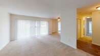 This single-floor residence offers a practical and comfortable layout designed for everyday living. The kitchen is appointed with warm oak cabinetry extending to the upper walls, dark laminate countertops, a gas range, dishwasher, and a double sink — all set atop durable tile flooring, providing a fully functional cooking space with ample storage.

The living area is generously sized, featuring neutral wall-to-wall carpeting and large sliding glass doors fitted with vertical blinds that allow substantial natural light to fill the room. A ceiling fan adds comfort, and an additional window further brightens the space with outdoor views of surrounding greenery.

The bedrooms are carpeted and spacious, each featuring large windows with horizontal blinds that invite natural light. One bedroom includes a built-in closet with bifold doors, while another connects directly to a private bathroom, offering added convenience. The bathrooms are cleanly appointed — one features a vanity with oak cabinetry, a mirror, and tile flooring, while the other includes a full bathtub and shower combination. Throughout, the residence maintains a neutral, light-toned palette that creates a calm and cohesive ambiance.