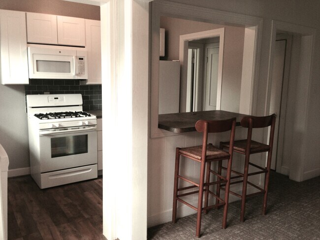 Dining room view of bar and kitchen. - 4104 Dover St