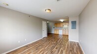 Located at 1904 S Rouse St in Pittsburg, Kansas, this single-story, 4-bedroom, 2-bathroom home offers a practical and well-organized layout. The open living and dining area is finished with durable wood-look flooring and neutral gray walls, creating a bright, versatile space. The kitchen flows naturally from the living area and features light wood cabinetry, a white appliance suite including an electric range and refrigerator, a built-in dishwasher, and a utility panel nearby for convenience. Both bathrooms are clean and functional, each equipped with a full tub-shower combination and chrome fixtures set against neutral-toned walls with matching wood-look flooring. The four bedrooms are carpeted in a warm beige tone, providing comfort underfoot, and each room benefits from natural light via windows with blinds. Several bedrooms include closets — some with sliding doors — while the home boasts a notable six closets total, offering generous storage throughout. A dedicated utility room and hallway round out the floor plan. The consistent use of neutral tones, wood-look flooring, and carpet creates a cohesive, move-in-ready interior suitable for a variety of living arrangements.