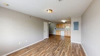 Located at 1904 S Rouse St in Pittsburg, Kansas, this single-story, 4-bedroom, 2-bathroom home offers a practical and well-organized layout. The open living and dining area is finished with durable wood-look flooring and neutral gray walls, creating a bright, versatile space. The kitchen flows naturally from the living area and features light wood cabinetry, a white appliance suite including an electric range and refrigerator, a built-in dishwasher, and a utility panel nearby for convenience. Both bathrooms are clean and functional, each equipped with a full tub-shower combination and chrome fixtures set against neutral-toned walls with matching wood-look flooring. The four bedrooms are carpeted in a warm beige tone, providing comfort underfoot, and each room benefits from natural light via windows with blinds. Several bedrooms include closets — some with sliding doors — while the home boasts a notable six closets total, offering generous storage throughout. A dedicated utility room and hallway round out the floor plan. The consistent use of neutral tones, wood-look flooring, and carpet creates a cohesive, move-in-ready interior suitable for a variety of living arrangements.