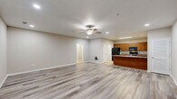 Located at 1300 Melody Lane in Valdosta, Georgia, this single-floor, 2-bedroom, 2-bathroom home offers a well-organized and functional layout. The open-concept living and dining area is spacious and bright, featuring light wood-style luxury vinyl flooring, neutral-toned walls, ceiling fans with integrated lighting, and recessed lighting that creates a clean, airy atmosphere throughout.

The kitchen is equipped with warm wood cabinetry, granite-style countertops, a full suite of black appliances including a refrigerator, electric range, microwave, and dishwasher, and durable tile flooring. A peninsula provides additional counter space and flows naturally into the dining and living areas. A pantry offers extra storage.

Both bedrooms continue the light flooring aesthetic and feature ceiling fans and generous closet space — one with louvered bifold doors and another with double doors. The primary bedroom is comfortably sized with natural light from a window. Each bathroom includes a full tub-shower combination with chrome fixtures and clean white finishes.

A dedicated in-unit laundry room accommodates a full-size washer and dryer. Additional utility rooms and a hallway connecting key spaces round out the thoughtful floor plan, making this home practical and comfortable for everyday living.